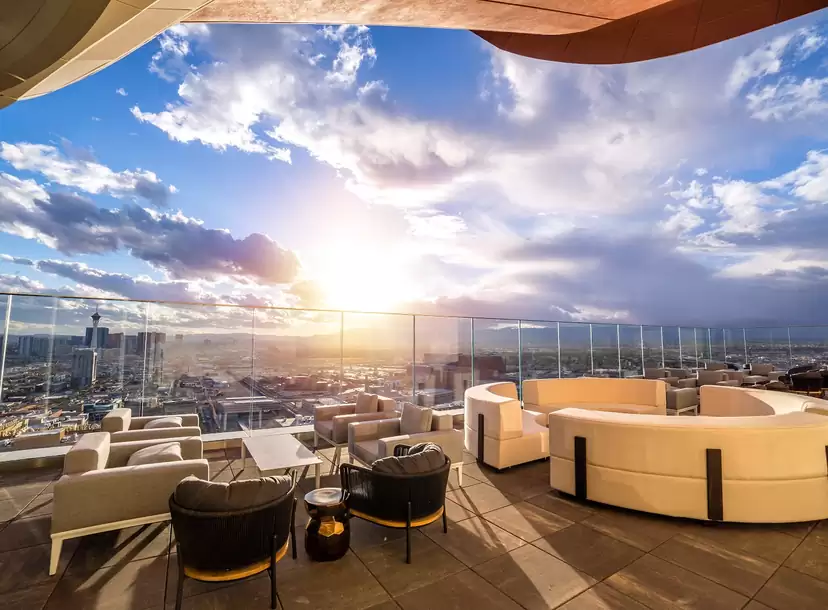 gorgeous rooftop bar during sunset with clouds overlooking the bar