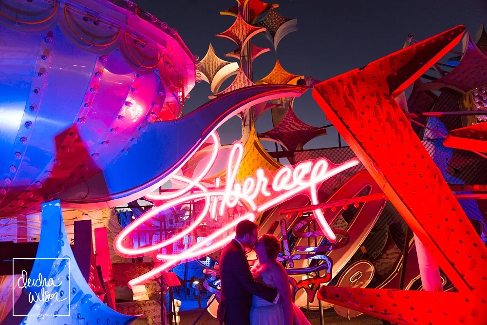 a couple getting married in front of the neon museum