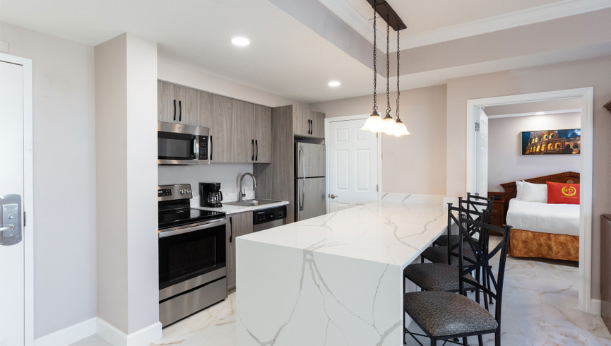 modern white kitchen with sleek counter light and breakfast bar